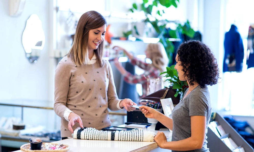 Woman paying at a clothing store