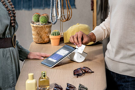 Woman using Elavon's Multi-Currency Conversion (MCC) System